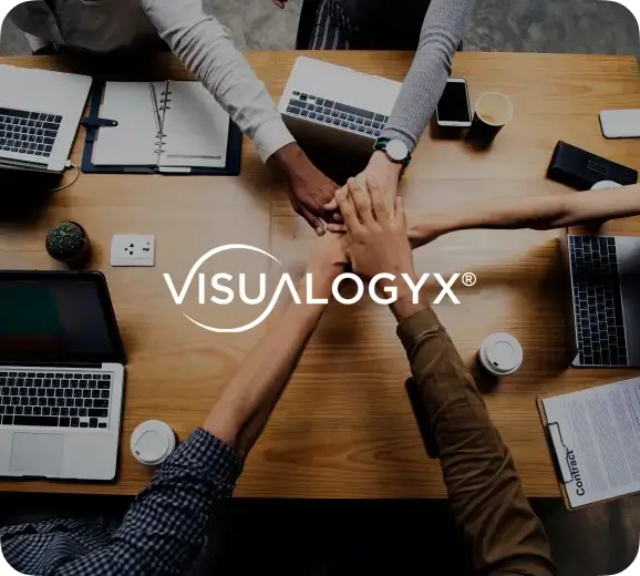 team bringing in hands over a table with the visualogyx logo